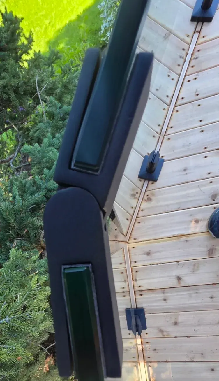 Glass spigot mounting hardware on a wooden deck railing