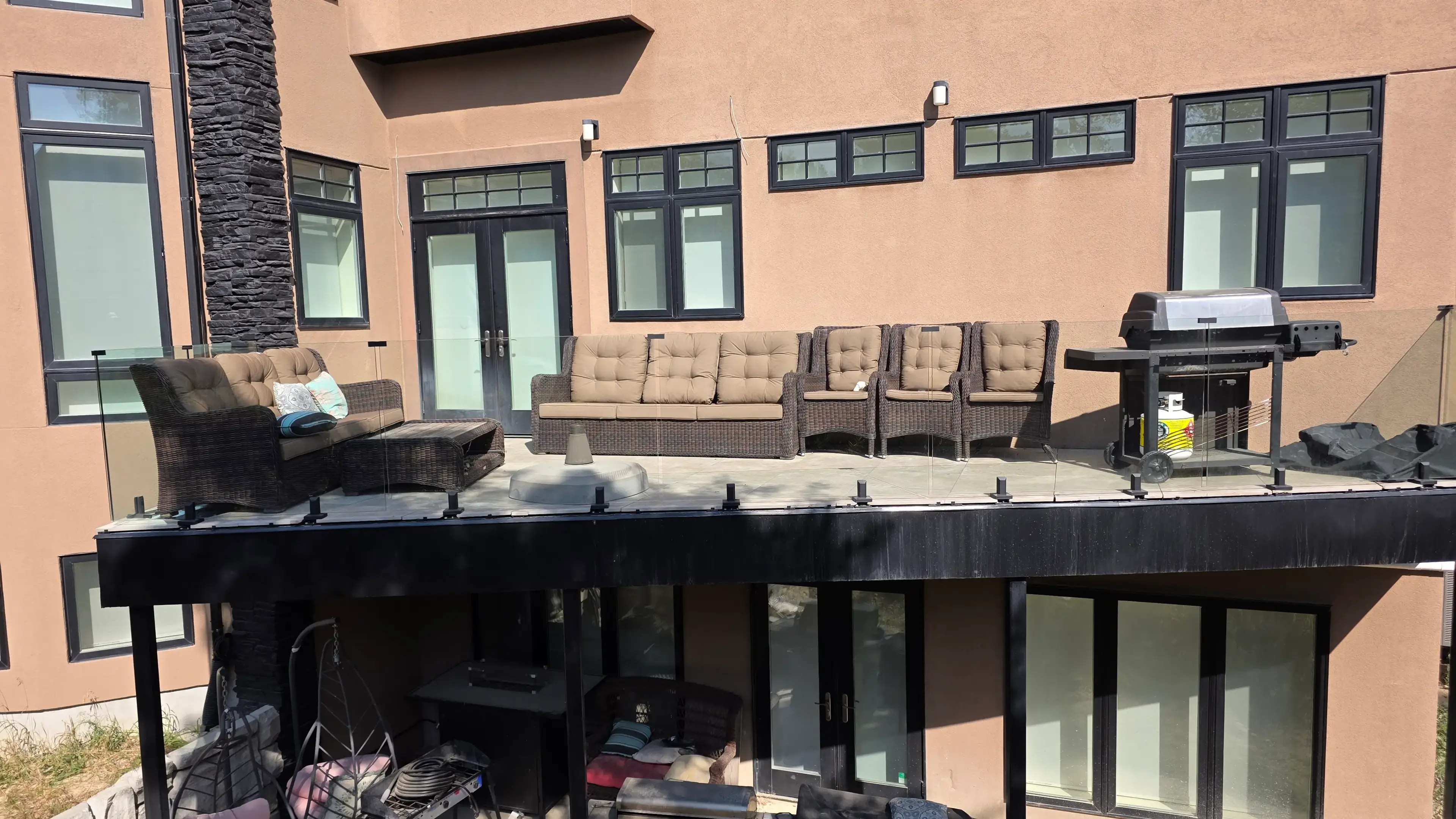 Glass panel railing secured with marine-grade spigots